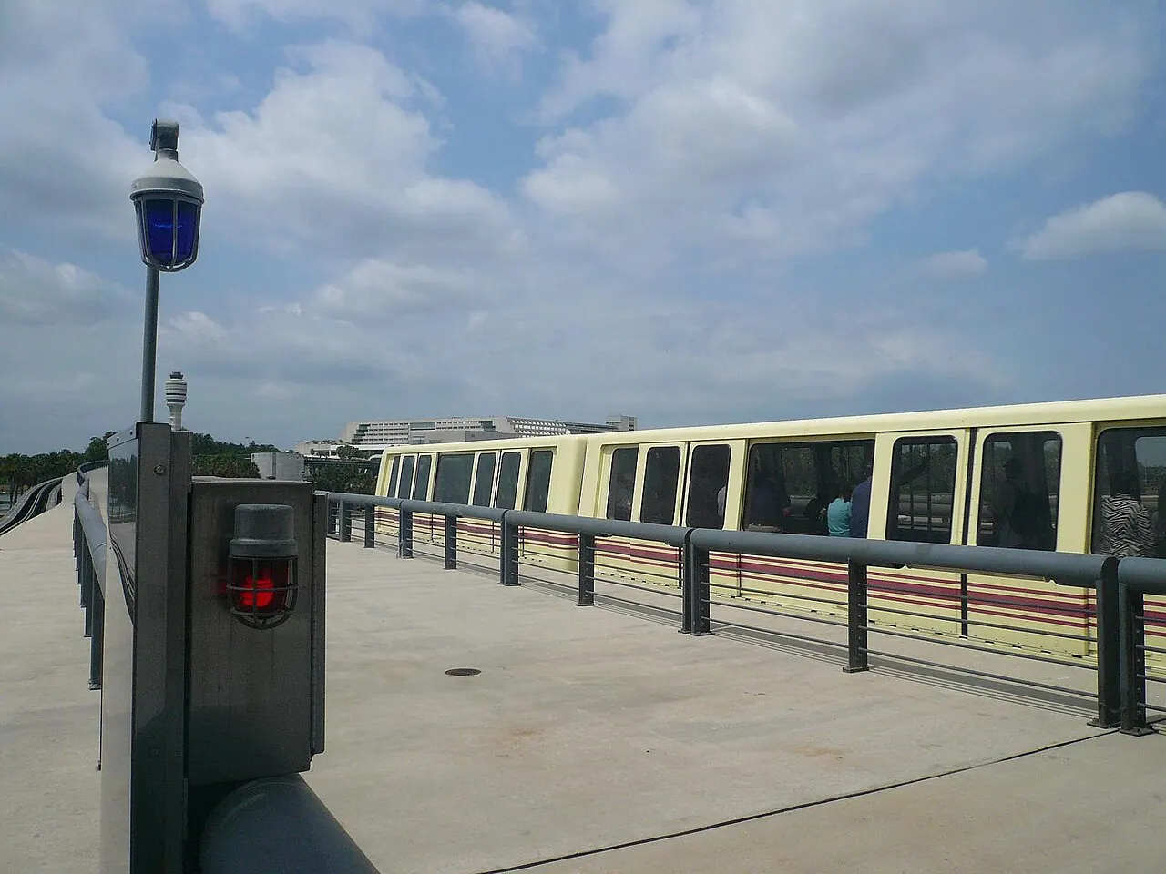 An airport people-mover train on elevated tracks at Orlando International Airport